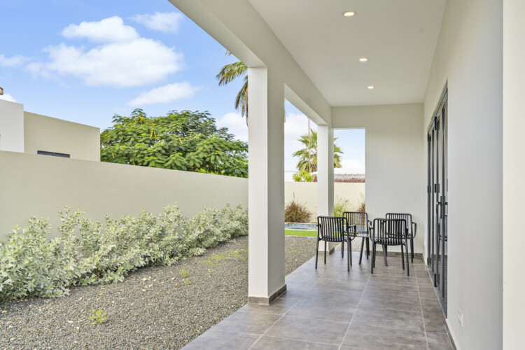 Covered terrace with outdoor dining area at Villa Blenchi Curaçao near Mambo Beach